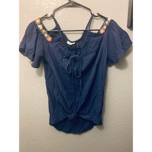Navy blue off the shoulder shirt. Likely worn